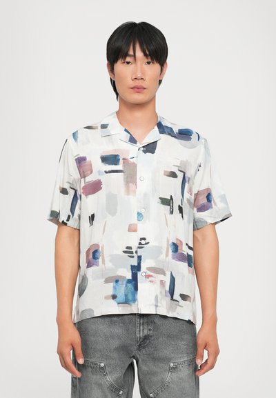 Chemise à manches courtes en tissu léger, présentant un motif abstrait aux couleurs comme le bleu, le rose et le gris. Design à col plat.