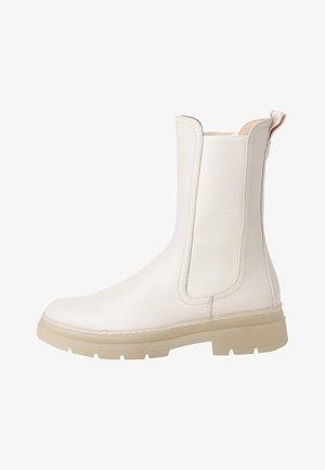 White ankle boot made of smooth leather, featuring elastic side panels, a pull tab, and a textured rubber sole.