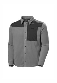Szara polarowa koszula z czarną górną częścią klatki piersiowej, posiadająca zapięcie na guziki, kieszeń na zamek oraz długie rękawy z zapięciem na guziki.
