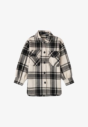 Camicia in flanella a quadri bianco e nero con maniche lunghe, due tasche frontali, chiusura con bottoni e una trama morbida.