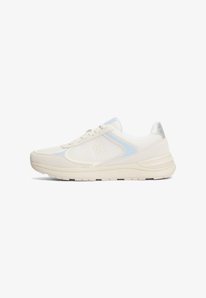 White athletic shoes with light blue accents, mesh and suede materials, textured sides, prominent logo on the side, and cushioned sole.