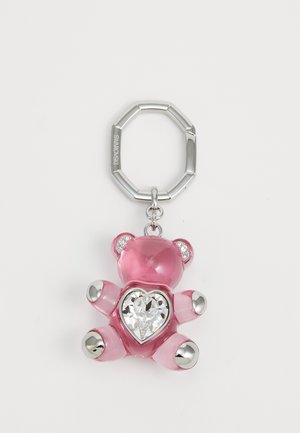 Pink bear keychain with a heart-shaped crystal center, silver metallic accents on paws, and a silver keyring; made of translucent material.