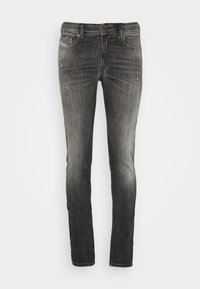 Jeans slim fit de color negro desgastados con ligero desgaste en los muslos delanteros y bolsillos, diseño de cinco bolsillos, cierre de botón y trabillas para cinturón.