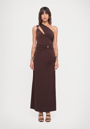 Asymmetrical brown dress with one shoulder, draped fabric, and a gathered waist detail with metal accent. Smooth texture, floor-length design.