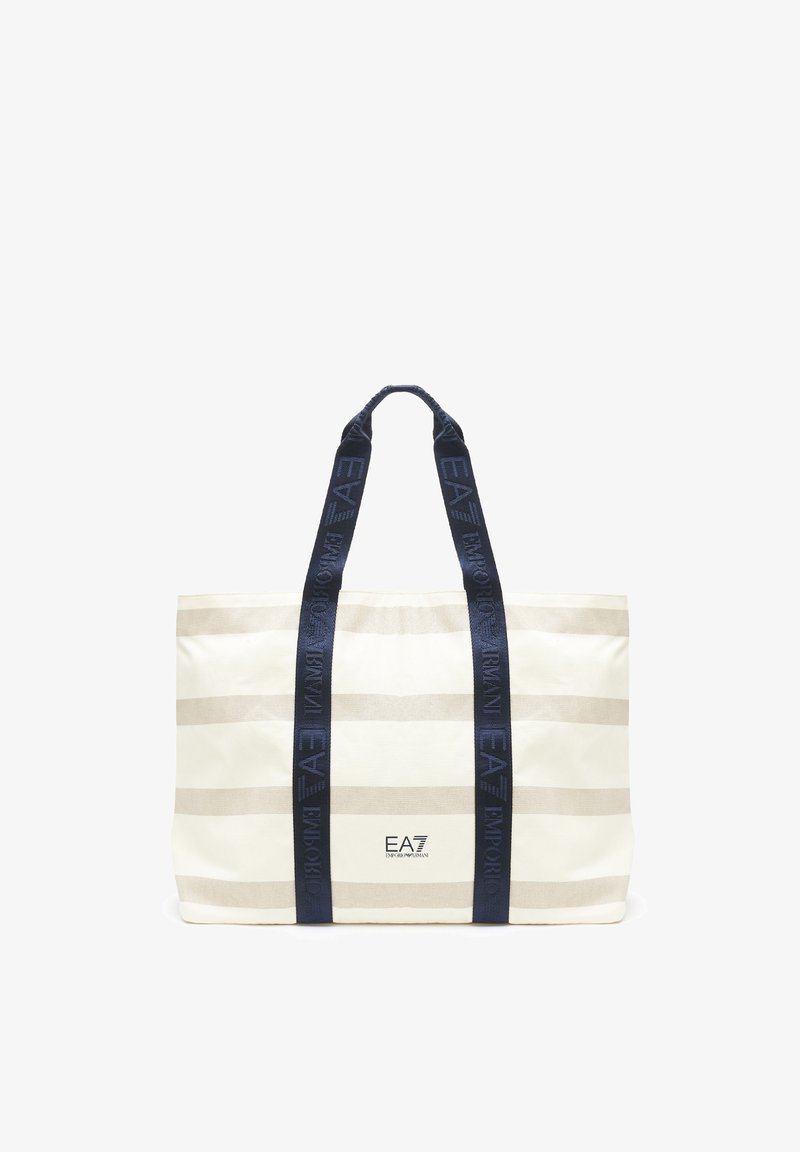 Borsa a spalla in tela a righe nei toni crema e beige, con manici blu scuro e dettagli con logo. Forma rettangolare con un ampio interno.