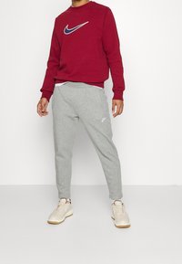 Nike Sportswear Träningsbyxor - light grey