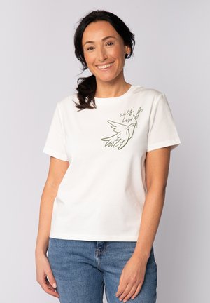 T-shirt en coton blanc avec un graphisme d'une colombe et le texte "self love" en vert. Manches courtes, col rond et coupe décontractée.