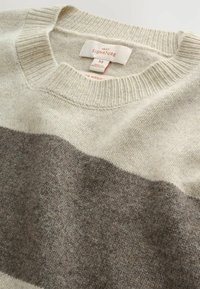 Light beige and grey striped sweater made of 100% merino wool. Features a ribbed crew neck and soft, textured fabric. Size M label visible.