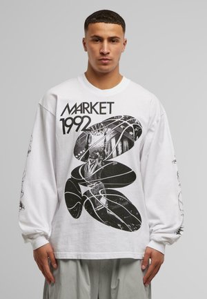Long-sleeve white t-shirt featuring black graphic print with "MARKET 1992" text and design elements, including abstract shapes and figures.
