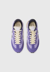 Purple mesh and suede sneakers with cream laces and logo on the tongue; black accents on sides; rubber sole with textured pattern.