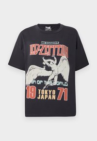 Black cotton t-shirt featuring a large graphic print of an angel with the text "Led Zeppelin in concert Tour of the World Tokyo Japan 1971."