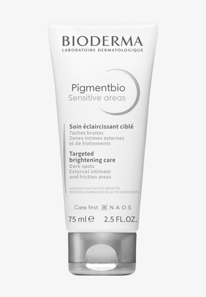 Tube blanc à finition brillante, étiqueté "Pigmentbio Zones sensibles", 75 ml. Présente un texte gris et un bouchon argenté. Produit dermatologique.