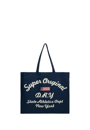 Sac cabas bleu marine avec deux poignées, affichant un texte blanc « Super Original D.R.Y State Athletics Dept New York » et un petit graphique du drapeau américain.