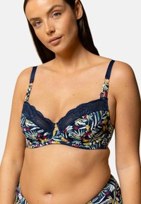 Soutien-gorge à motif floral marine avec des accents jaunes et rouges. Comprend une bordure en dentelle et des bretelles réglables avec des accessoires décoratifs.