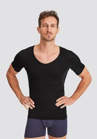 Black short-sleeve V-neck shirt made from a smooth fabric, fitted design with side panels, worn with navy blue boxer briefs.