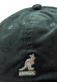 Green corduroy cap featuring an embroidered kangaroo logo in beige on the front. Includes a button top and textured ribbed surface.