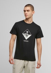 Černé bavlněné tričko s bílou šamponovou grafikou ve tvaru diamantu, kterou zdobí palma a oceánské vlny. Krátké rukávy, design s kulatým výstřihem.
