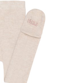 Collant beige in maglia con una morbida texture. Include un berretto abbinato con il logo rosa chiaro "HUST CLVNE" sul risvolto.