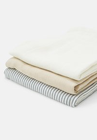 Set of three folded kitchen towels: cream, beige, and striped blue and white. Each towel features a textured woven material.