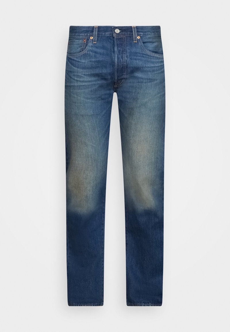 Jean en denim bleu avec des zones délavées sur les cuisses et les genoux, doté de poches avant et de passants pour ceinture.