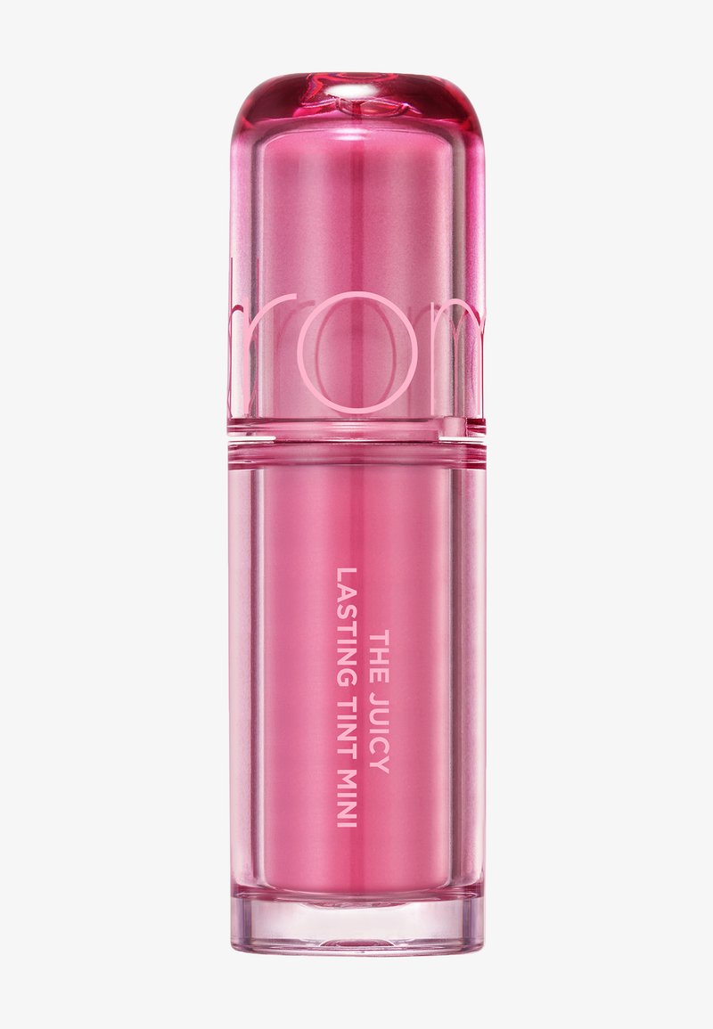 Pink cylindrical lip tint container with rounded cap, labeled "THE JUICY LASTING TINT MINI" in white text.