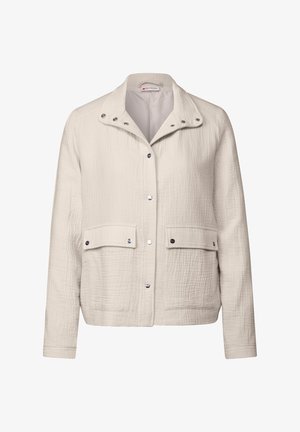 Jasbeżowa kurtka wykonana z teksturowanej tkaniny. Posiada kołnierzyk, zatrzaski oraz dwie przednie kieszenie z klapami.