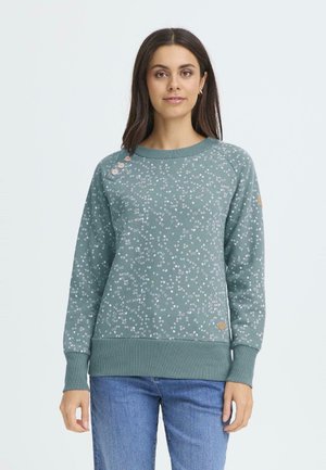 Sweatshirt, teal med spridda vita och rosa prickar, ribbade muddar och nederkant, rund halsringning, subtila knappar på axeln, mjuk textur.