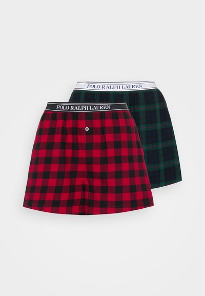 Δύο ζεύγη βαμβακερών σλιπ, ένα σε κόκκινο και μαύρο καρό και ένα σε σκούρο πράσινο και μαύρο καρό, με λωρίδα μέσης μάρκας σε μαύρο χρώμα.