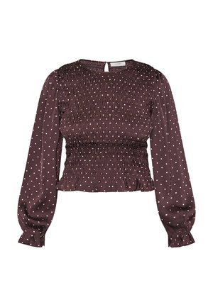 Mørk lilla langærmet bluse med hvide prikker, smocket bodice, elastiske manchetter og en lille knaplukning bagpå.
