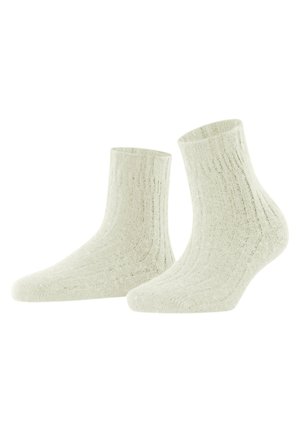 Geribbelde enkelkousen in off-white, gemaakt van een zacht materiaal. Heeft een textuur en een aansluitend ontwerp voor comfort.