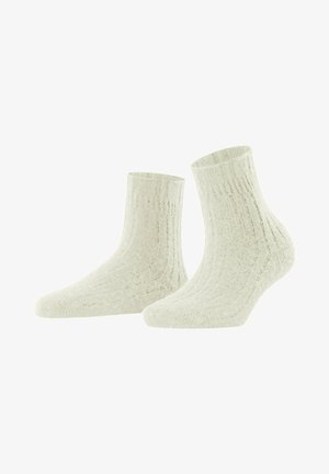 Chaussettes chevilles côtelées en écru, fabriquées à partir d'un matériau doux. Présentent une surface texturée et un design ajusté pour le confort.