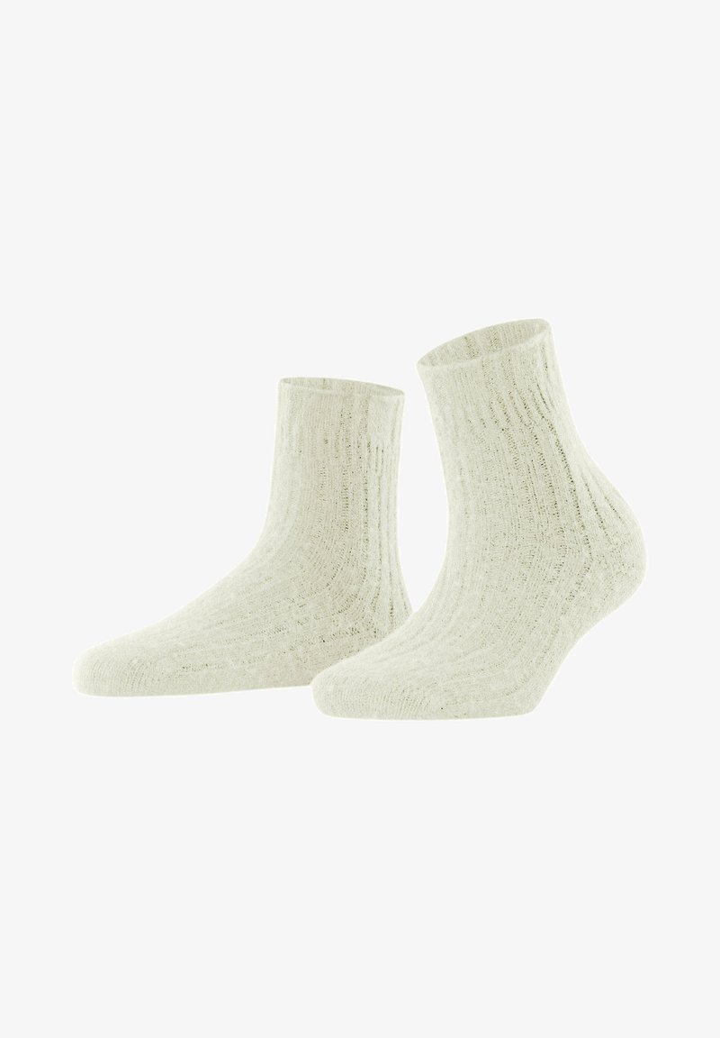 Calzini alla caviglia a coste in off-white, realizzati in un materiale morbido. Presentano una superficie testurizzata e un design aderente per il massimo comfort.