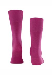 Różowe bawełniane skarpetki z bezszwowym wzorem, ściągaczami prążkowanymi i gładką fakturą. Mają długość do połowy łydki i jednolity kolor.