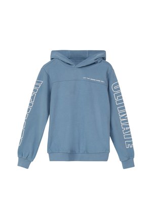 Sweatshirt à capuche bleu avec du texte blanc sur les manches disant "ULTIMALE" et un petit texte sur la poitrine disant "LAISSEZ LE SON VOUS GUIDER !"