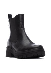 Stivaletto in pelle nera con pannelli laterali elasticizzati, suola spessa e texture, punta tonda e linguetta per un facile indossamento.