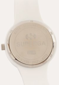 White silicone watch with a stainless steel back, featuring "SUPERGA" engraved, a round shape, and a textured bezel with water resistance marking.