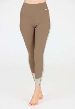 Braune hochtaillierte Leggings aus elastischem Material, mit beigen Akzenten an den Seiten und einer glatten Textur.