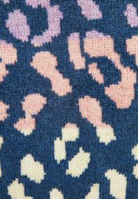 Tissu tricoté avec un motif léopard irrégulier en bleu foncé, rose clair et crème.