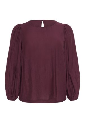 Blouse bordeaux avec une texture côtelée, col rond et détail en forme de trou de serrure au dos. Caractéristiques : manches longues froncées avec des poignets élastiques.