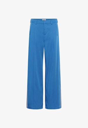 Laiade säärtega püksid erk sinises toonis, valmistatud pehmest kangast. Esiküljel taskud ja külgedel kontrastsed triibud.