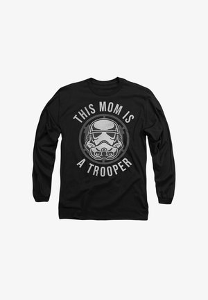 Black long-sleeve t-shirt featuring a stormtrooper helmet graphic with "THIS MOM IS A TROOPER" text in silver around it. Cotton material.