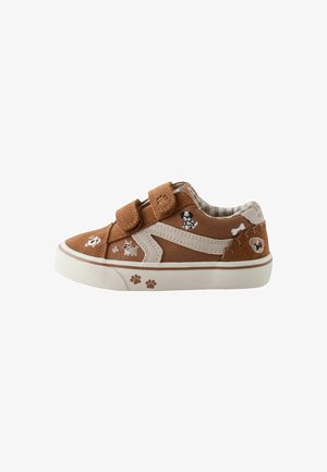 Brown suede sneakers with a white stripe, two Velcro straps, and animal motifs. Textured sole, featuring paw prints and playful details.