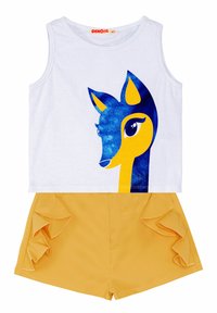 White sleeveless top with a blue and yellow deer graphic; paired with yellow shorts featuring ruffled side accents. Cotton material.