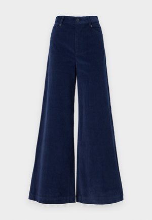 Marineblaue, weit geschnittene Cordhosen mit hoher Taille, die über Fronttaschen und einen Knopfverschluss verfügen. Weiche Textur und fließende Silhouette.