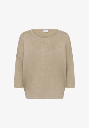 Top de manga larga suelto de color beige claro, con cuello redondo, textura acanalada y aberturas laterales para facilitar el movimiento. La etiqueta dice "Saint".