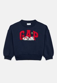 Tengerészkék kapucnis pulóver pamutból, piros "GAP" logóval. Hímzett Snoopy mintával, napszemüvegben és sárga díszítéssel.