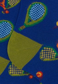 Cotton blend socks featuring a blue background with green and patterned tennis rackets, fruit motifs, and contrasting ribbed cuffs.
