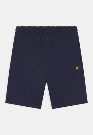 Shorts de algodón azul marino con cintura elástica, cordón ajustable, bolsillos laterales y un pequeño logo de águila amarilla en la pierna izquierda.