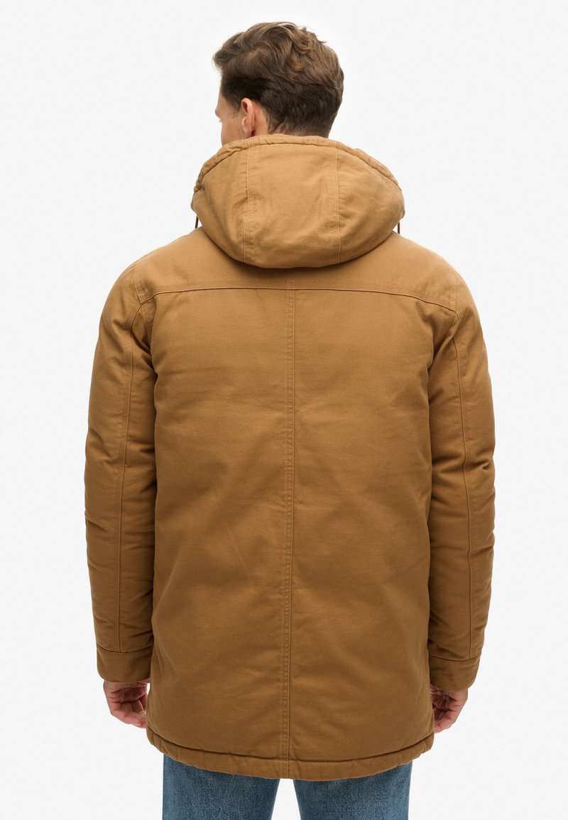 Bruine parka-jack met capuchon en een gestructureerde afwerking, met een rechte snit, elastische manchetten en een zoom die onder de taille uitkomt.