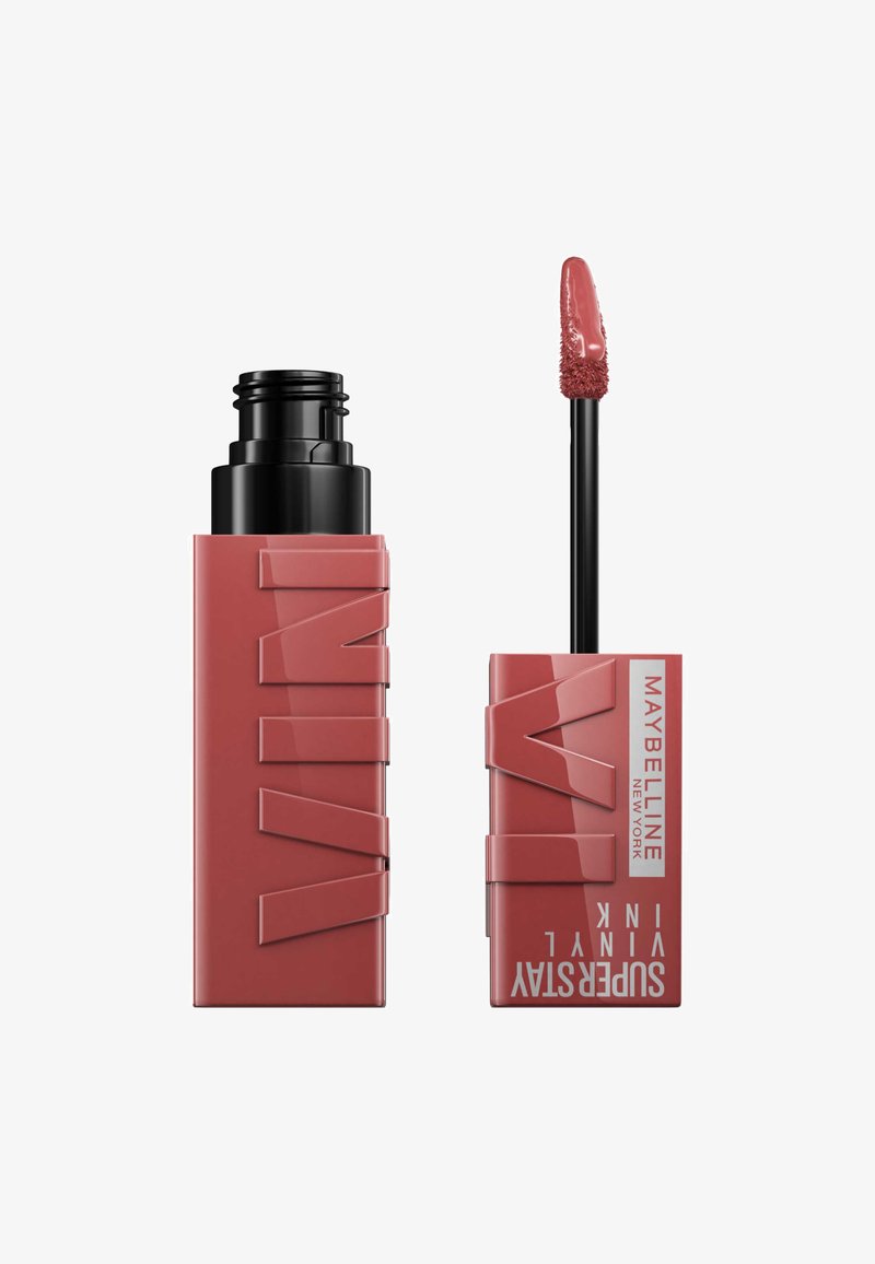 Rossetto liquido Maybelline Superstay Vinyl Ink in rosa polveroso, con applicatore a bacchetta e confezione rettangolare rosa e nera.
